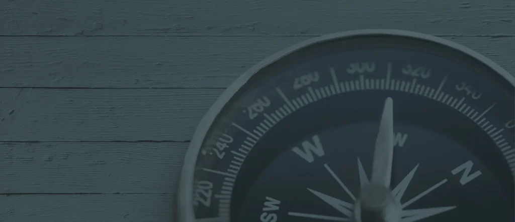 Compass On Rustic Wooden Background